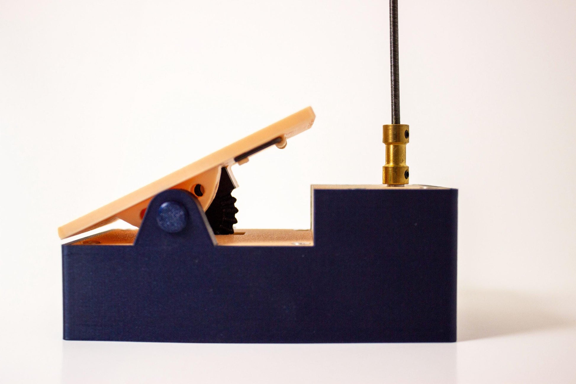 Profile view of an expression guitar pedal called the Toe-N Control with its pedal component in the upright position