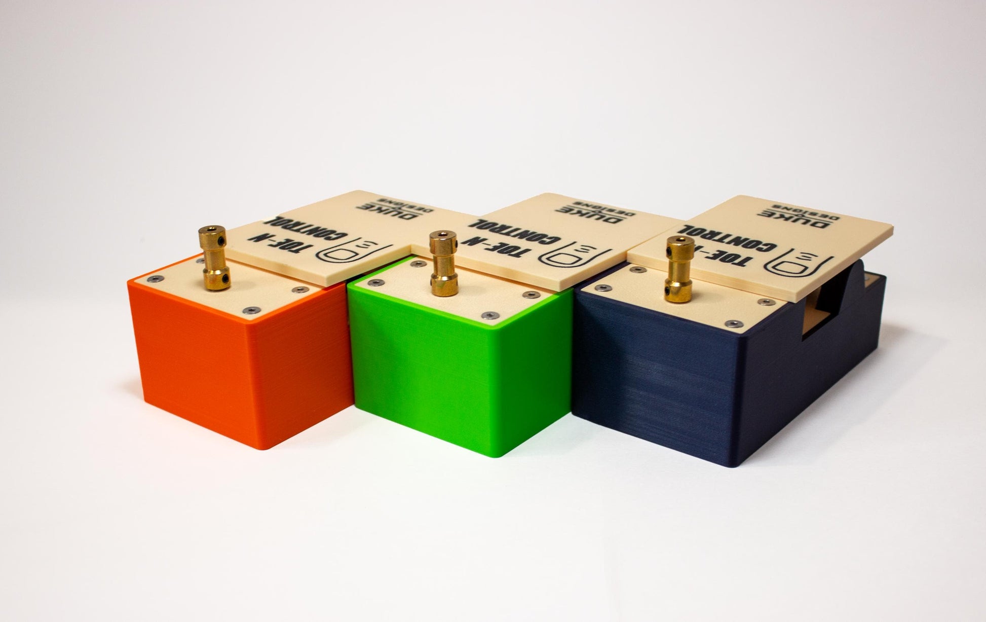 Three guitar pedals individually colored orange, green and blue